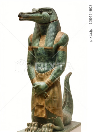 Sobek, the ancient Egyptian god of the Nile and fertility, is standing in a museum with his arms at his sides Sobek, the ancient Egyptian god of the Nile and fertility, is standing in a museum with his arms at his sides 130454608