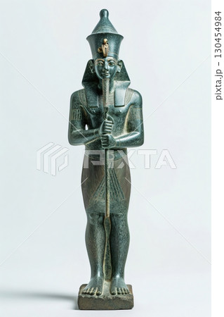 Ancient Egyptian statue of Osiris, god of the underworld, standing and holding the crook and flail 130454984