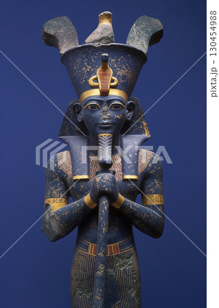 Ancient Egyptian statue of Osiris, god of the underworld and resurrection, holding the crook and flail 130454988