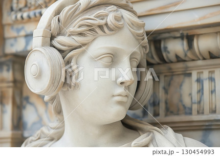 Classical marble statue of Athena, the Greek goddess of wisdom, is wearing a modern set of headphones 130454993