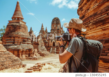 Photographer is capturing the beauty of ancient asian temple ruins, immersing himself in the rich history and culture 130455245