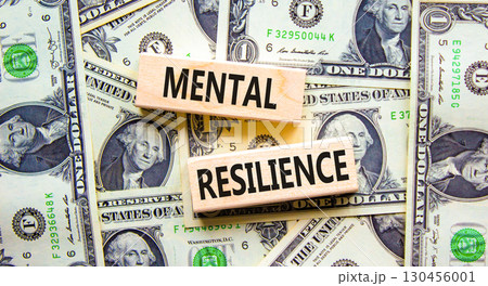 Mental resilience symbol. Concept word Mental resilience typed on wooden blocks. Beautiful background from dollar bills. Business psychological and mental resilience concept. Copy space. 130456001