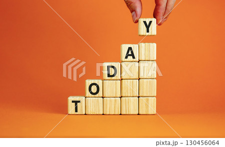 Today symbol. Concept word Today on beautiful wooden blocks. Beautiful orange table orange background. Businessman hand. Business lifestyle today concept. Copy space. 130456064
