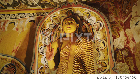 Majestic Buddha Statue Surrounded by Vibrant Wall Art Majestic Buddha Statue Surrounded by Vibrant Wall Art 130456450