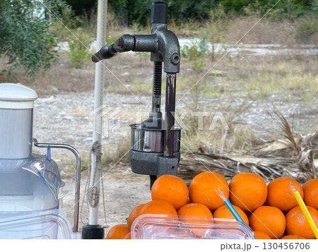 Oranges with juice press on a stall. Fresh fruit, refreshment and healthy lifestyle. Oranges with juice press on a stall. Fresh fruit, refreshment and healthy lifestyle. 130456706