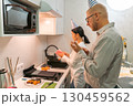 Couple Kitchen Birthday Party: Celebrating intimate birthday, cooking meal, modern apartment kitchen. 130459562