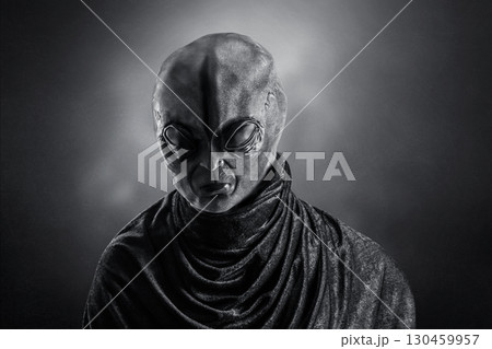 Mysterious humanoid alien at night over dark misty background Mysterious humanoid alien at night over dark misty background 130459957