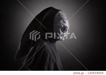 Mysterious humanoid alien at night over dark misty background Mysterious humanoid alien at night over dark misty background 130459959