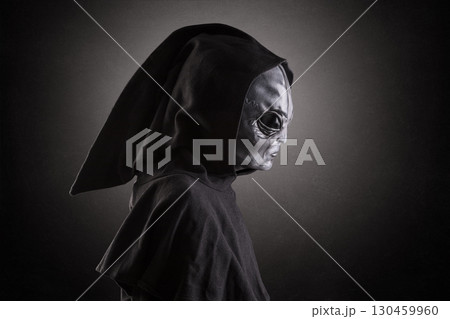 Mysterious humanoid alien at night over dark misty background Mysterious humanoid alien at night over dark misty background 130459960