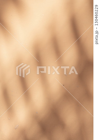 Wall with texture and shadows. Orange, brown concrete background 130460229