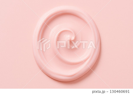 Smooth pink cosmetic cream swirl on pastel background evokes sense of beauty and self care, perfect for skincare product displays 130460691