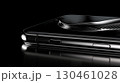 Digital hologram rising from smartphone, projecting luminous data visualization in darkened environment, revealing cutting edge mobile technological advancement 130461028