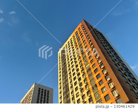 A high-rise apartment building on a blue sky background. New building. High quality photo 130461429