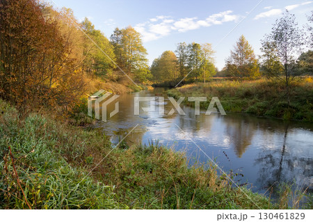 A bridge over a body of water surrounded by trees A bridge over a body of water surrounded by trees 130461829