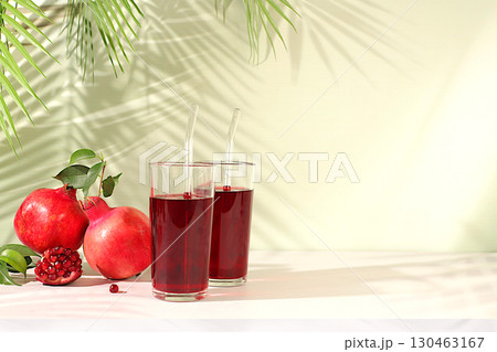 Pomegranate juice drink and ingredients, rich pomegranate drink on elegant sunny table, detox diet and weight loss concept, natural food for healthy lifestyle, source of vitamin C Pomegranate juice drink and ingredients, rich pomegranate drink on elegant sunny table, detox diet and weight loss concept, natural food for healthy lifestyle, source of vitamin C 130463167