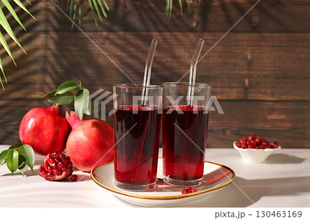 Pomegranate juice drink and ingredients, rich pomegranate drink on elegant sunny table, detox diet and weight loss concept, natural food for healthy lifestyle, source of vitamin C 130463169