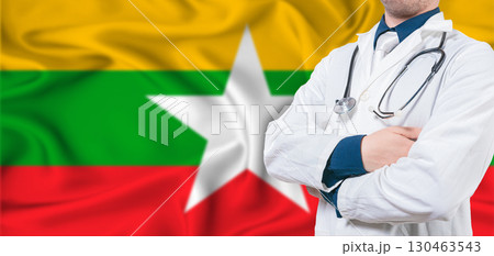 Myanmar healthcare concept. Male doctor on Myanmar flag. Doctor with crossed arms on Myanmar flag 130463543