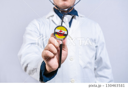 Doctor hands holding stethoscope with Brunei flag. Brunei health and care concept 130463581