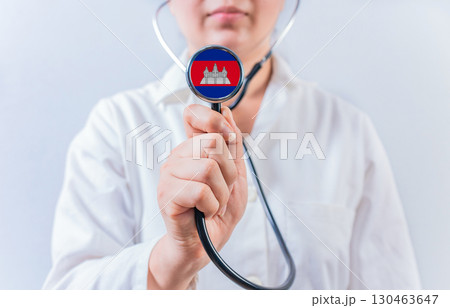 Female doctor holding stethoscope with Cambodia flag. National health system of Cambodia Female doctor holding stethoscope with Cambodia flag. National health system of Cambodia 130463647