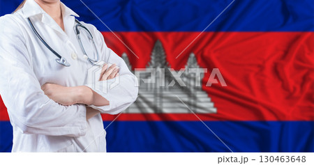 Doctor with crossed arms on Cambodia flag. Cambodia health and care concept. Female doctor on Cambodia flag 130463648