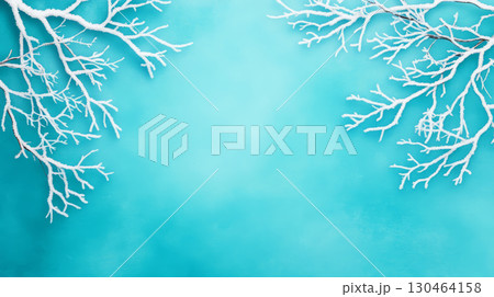 Frosted tree branches create serene winter scene against turquoise background, evoking sense of calm and tranquility. icy details enhance beauty of season 130464158