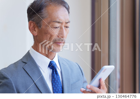 スマホを使うシニアビジネスマン 130464776