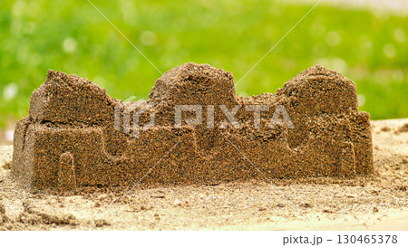 Sand fortress wall created by kids in play 130465378