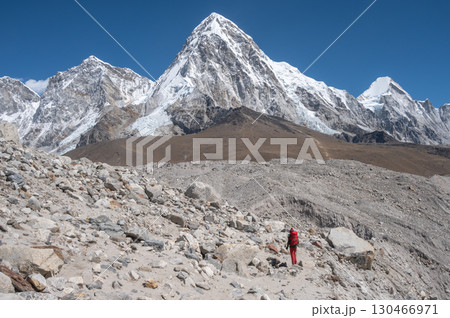 Toruist while walking to Everest base camp with beautiful view of Mt.Pumori (7,165 m) with other Himalayas range in Sagarmatha national park, Nepal. Toruist while walking to Everest base camp with beautiful view of Mt.Pumori (7,165 m) with other Himalayas range in Sagarmatha national park, Nepal. 130466971