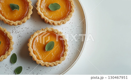 Mini pumpkin pie tarts snack dessert homemade in white plate copy space background 130467951
