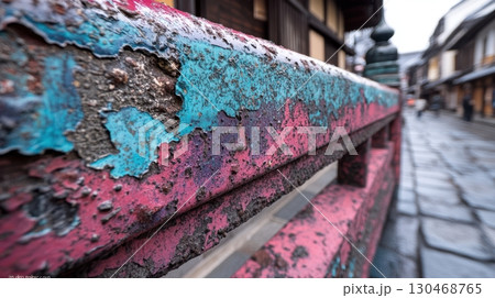Colorful weathered railing along a quiet street in a traditional Japanese town during a rainy day 130468765