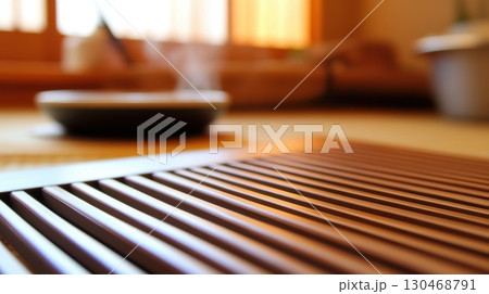 Warm steam rises from a bowl in a tranquil Japanese room with wooden flooring and gentle sunlight 130468791