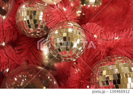 Glamorous Disco Ball Ornaments Adorn a Festive Christmas Tree 130468912