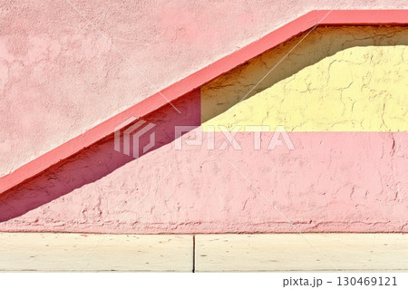Colorful geometric design of a wall and steps in bright pink and yellow tones during daylight 130469121