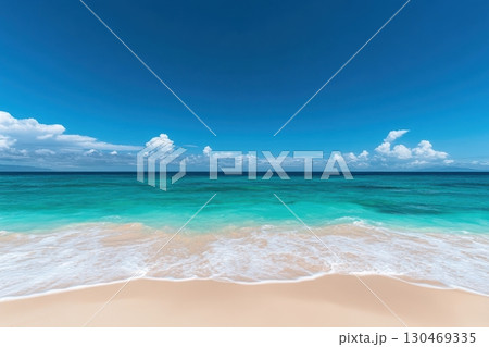 Vibrant ocean meets sandy beach under a clear blue sky at midday 130469335