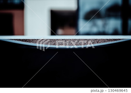 Close-up view of a curved surface highlighting texture and depth in urban architecture 130469645