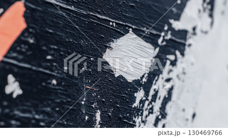 Close-up view of textured wall revealing layers and colors in urban setting during daylight hours 130469766