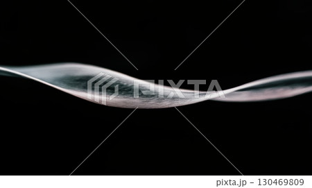 Gentle wave of translucent material gliding through dark space creates a serene and calming visual effect 130469809