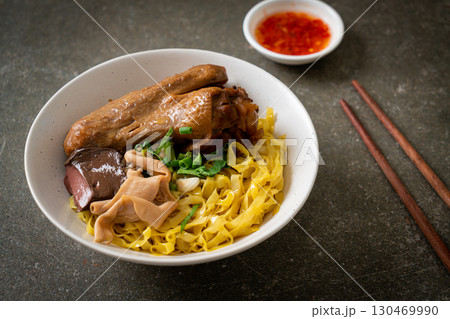 Egg noodles served dry with braised duck Egg noodles served dry with braised duck 130469990