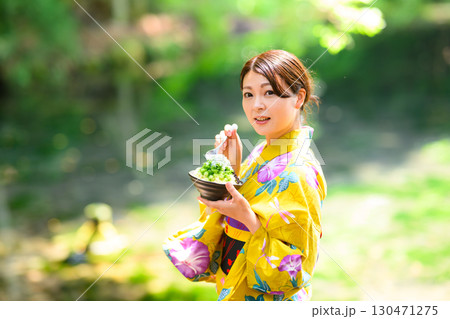 高原の湖で浴衣を着た女性がかき氷を食べている 130471275