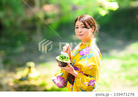 高原の湖で浴衣を着た女性がかき氷を食べている 高原の湖で浴衣を着た女性がかき氷を食べている 130471276