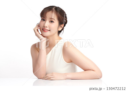 A beautiful young Asian woman with clean, fresh skin against a white background. Skincare, facial treatment, cosmetology, beauty, and spa. An elegant portrait of an Asian woman. A beautiful young Asian woman with clean, fresh skin against a white background. Skincare, facial treatment, cosmetology, beauty, and spa. An elegant portrait of an Asian woman. 130472212