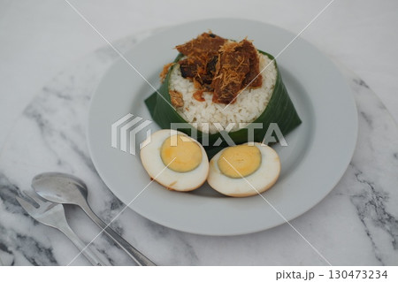 Nasi Lemak with Egg and Fried Crispy Rendang Beef on a Plate Nasi Lemak with Egg and Fried Crispy Rendang Beef on a Plate 130473234