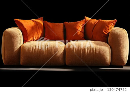 Modern beige sofa with orange pillows soft texture dark background 130474732
