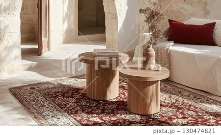 Wooden side tables and patterned rug in sunlit interior 130474821