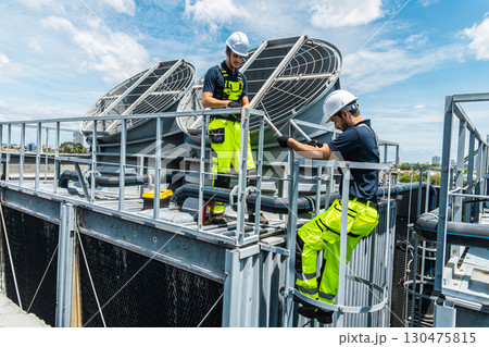 Professional worker servicing HVAC building cooling tower, Industry air conditioner service Professional worker servicing HVAC building cooling tower, Industry air conditioner service 130475815