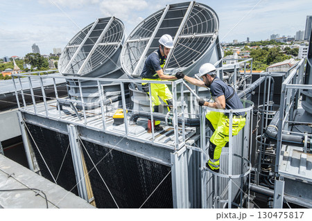 Professional worker servicing HVAC building cooling tower, Industry air conditioner service Professional worker servicing HVAC building cooling tower, Industry air conditioner service 130475817
