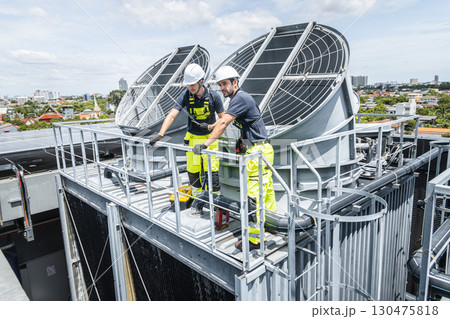 Professional worker servicing HVAC building cooling tower, Industry air conditioner service Professional worker servicing HVAC building cooling tower, Industry air conditioner service 130475818