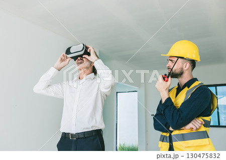 Construction project manager using VR visual modern technology device with engineer builder at site Construction project manager using VR visual modern technology device with engineer builder at site 130475832