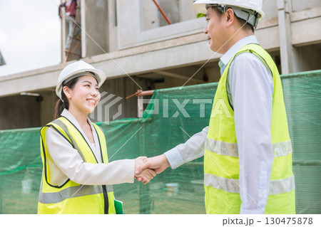 Construction project engineer team joint meeting hand shaking together at construction site Construction project engineer team joint meeting hand shaking together at construction site 130475878