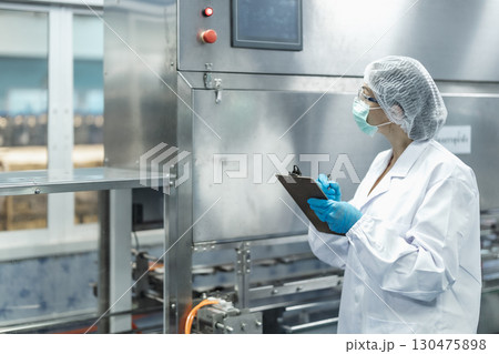 Industry inspector team working, QC staff work checking machine operation for safety and hygiene 130475898